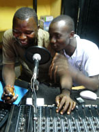 Two young Sierra Leoneans in front of a sound mixer. Photo by Michael Stasik