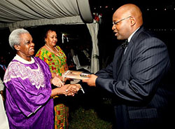 Picture #4 Joseph Kahama offers a copy of his book to Mama Maria Nyerere, wife of the late president